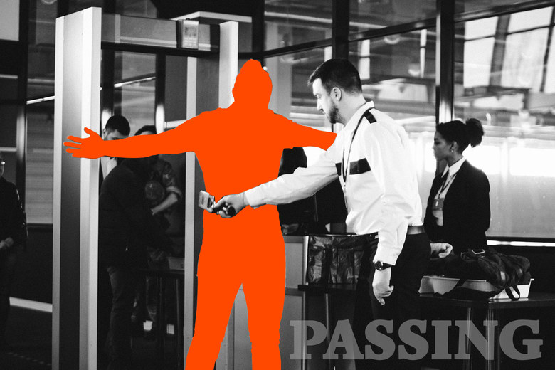 A silhouetted person going through airport security.
