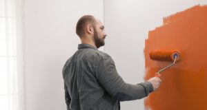 Apartment Decorating Ideas for a Stylish Denver Lifestyle Man renovating apartment with orange paint